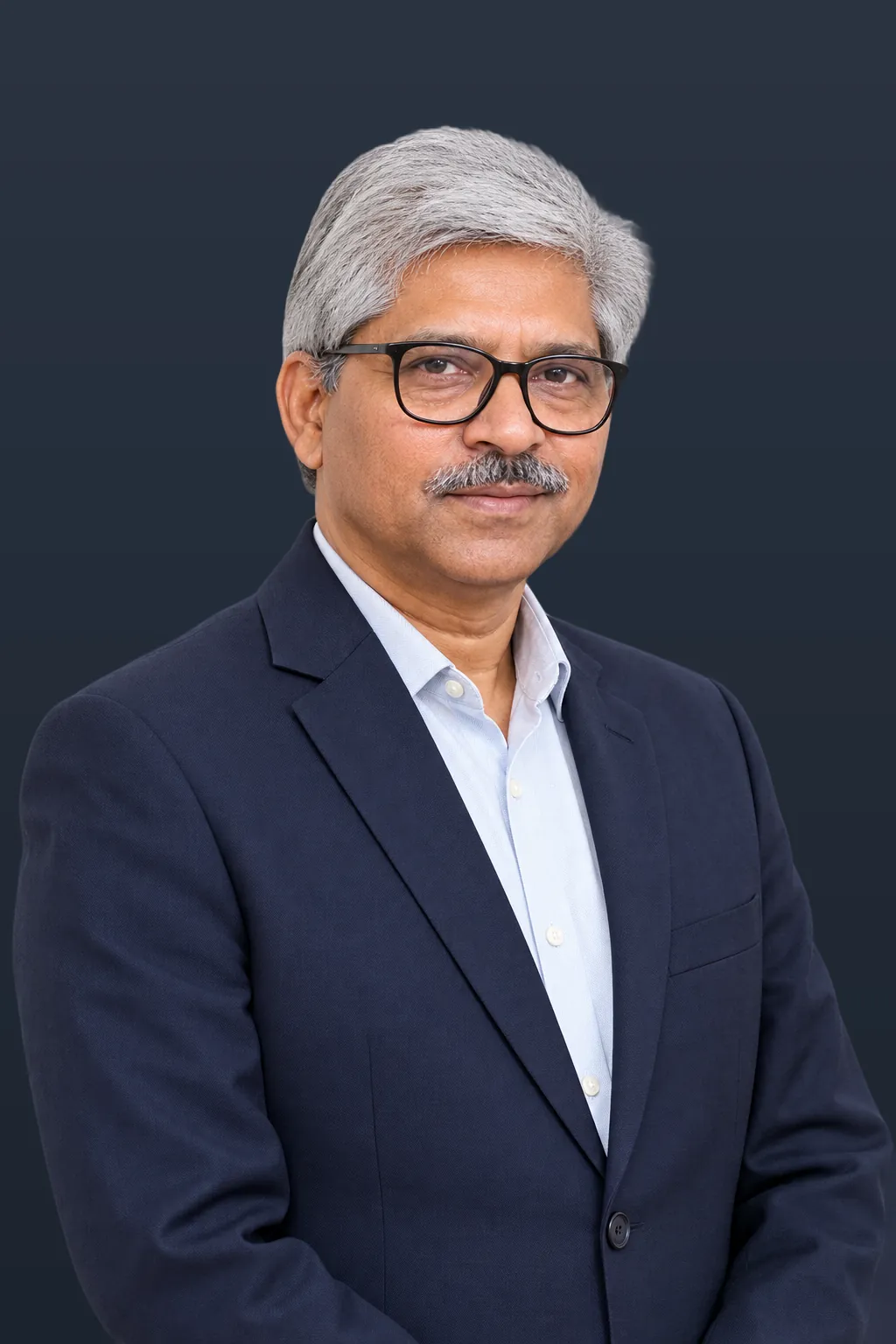 Portrait of Rajender Kumar Sharma in a navy suit